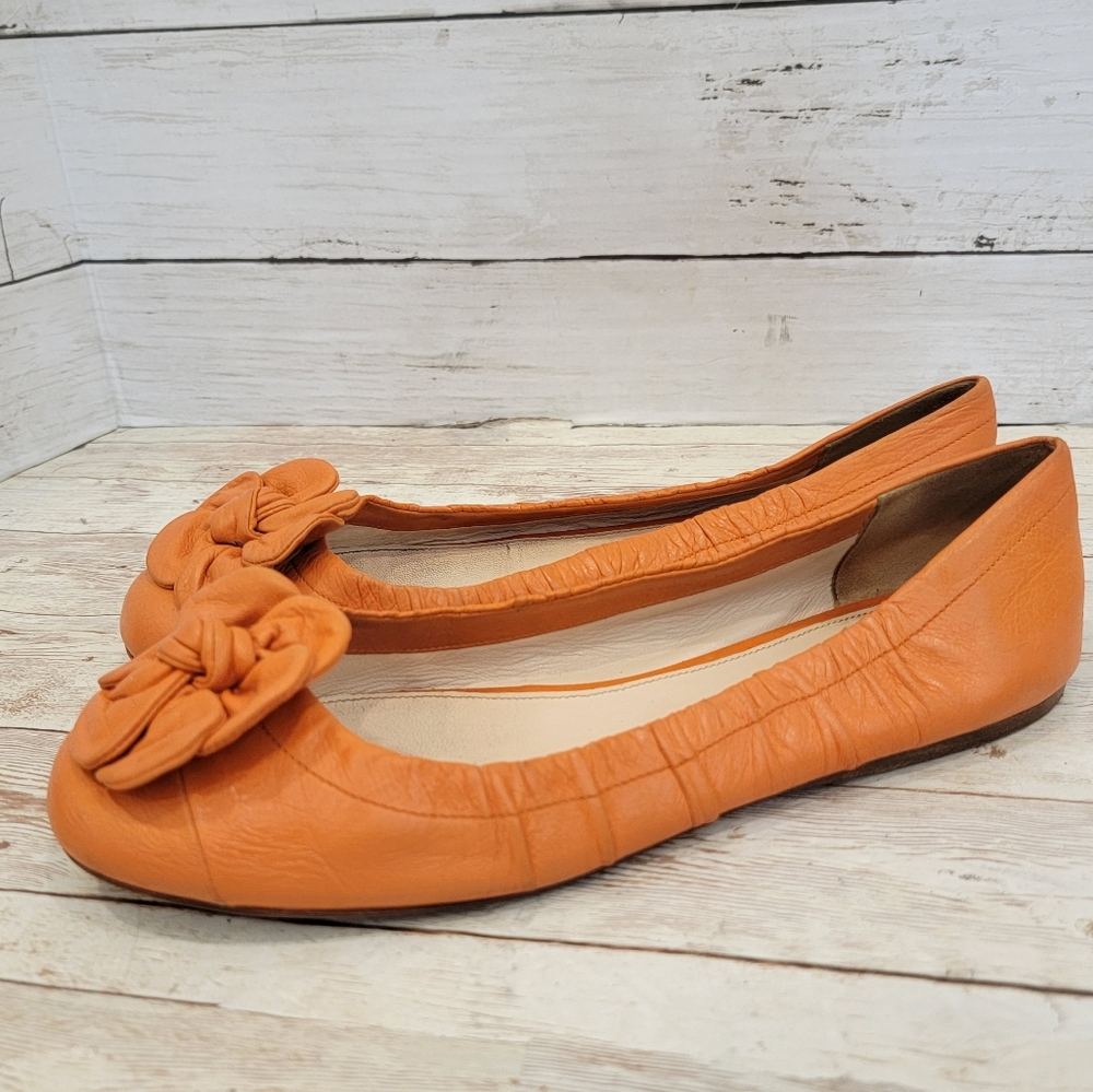 Prada orange leather ballet flats with flower
